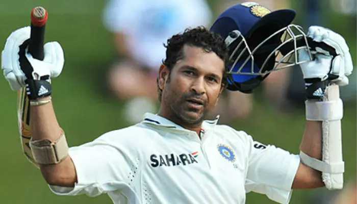 Sachin Tendulkar celebrates after scoring a century in a Test Match.